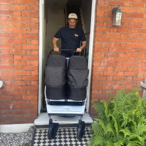 Dad pushing twins out the front door in Mountain Buggy Duet V4