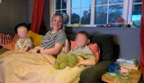 Mum and two kids testing out the Dreamland cafe collection heated throw