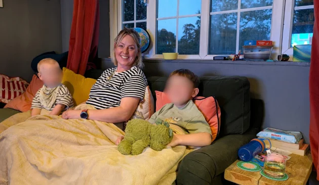 Mum and two kids testing out the Dreamland cafe collection heated throw