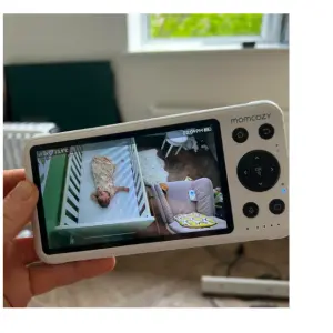 Mum holding parent unit Momcozy Smart Baby Monitor BM04
