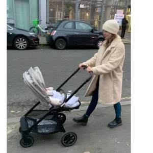 Mum pushing baby in Nuna Triv Next