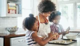 A mother and kids making biscuits in the kitchen
