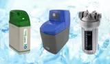 Three water softeners lined up on a blue and white watery background