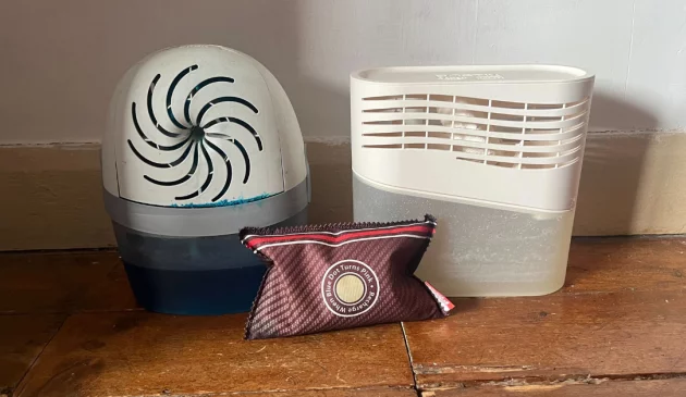 Three moisture absorbers being hand tested by Mumsnet journalist Poppy O'Neill