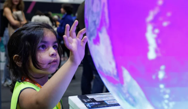 Child exploring installation at New Scientist Live