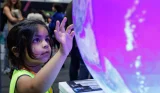 Child exploring installation at New Scientist Live
