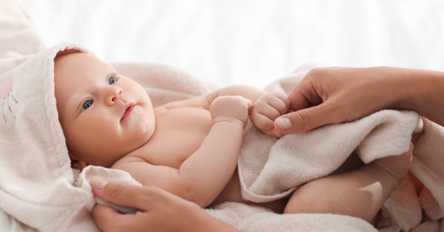 Baby wrapped in towel after bathtime