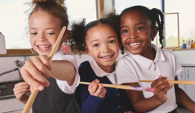 Three children wearing NEXT back to school clothing