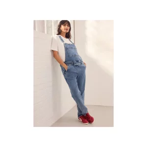 Next Maternity Denim Dungarees stock image of model from front leaning against wall