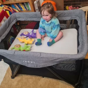 Nuna Sena Aire travel cot review image with baby