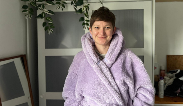 A woman in a dressing gown smiling