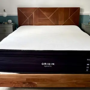 A view of the Origin Hybrid Pro Mattress atop a kingsize bed frame