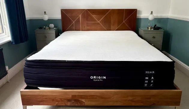 A view of the Origin Hybrid Pro Mattress atop a kingsize bed frame