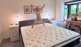 A young girl jumps on top of an Origin LumbarCloud mattress