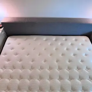 From above, the Origin LumbarCloud Mattress next to bed side tables