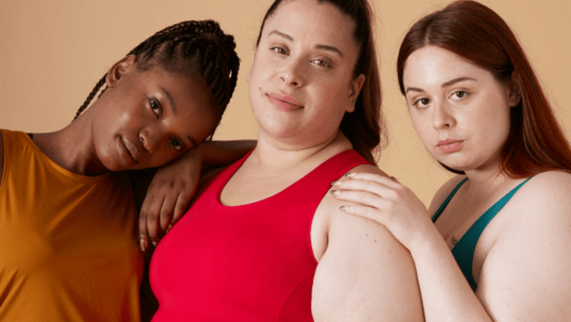 Three women are stood next to each other looking at the camera