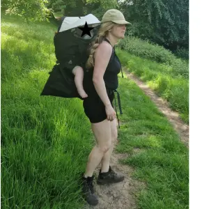 Mum using Out n About Nipper Trek baby carrier backpack