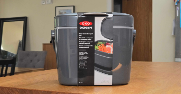 A look at the OXO Good Grips Easy-Clean Compost Bin in its original packaging atop a kitchen worktop
