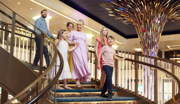 P&O Cruises family coming down stairs on ship