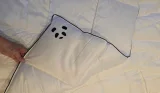 A hand holds the Panda Cloud Bamboo Duvet