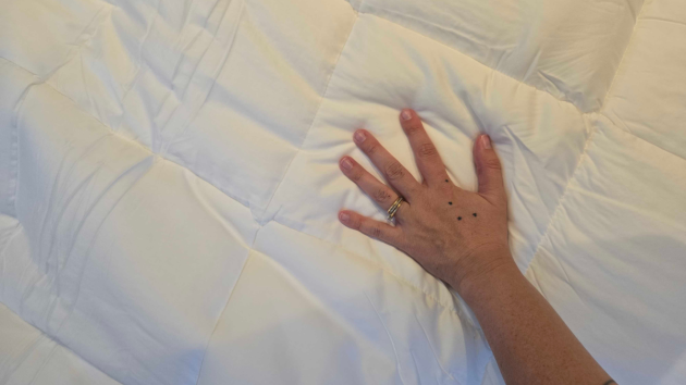 A hand touches the Panda bamboo duvet