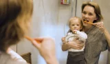 Mum and baby brushing teeth