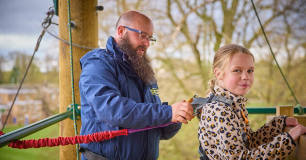 A member of staff helping a child at PGL Kids’ Adventure Camps