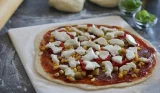 Pizza cooking on a pizza stone
