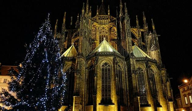 Famous Prague architecture with Christmas tree beside