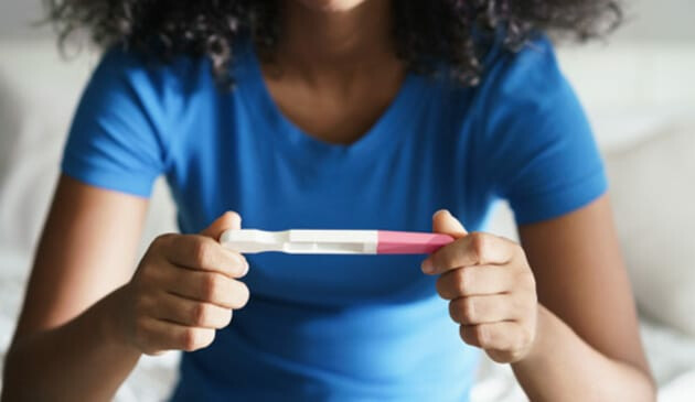 Woman looking at a pregnancy test