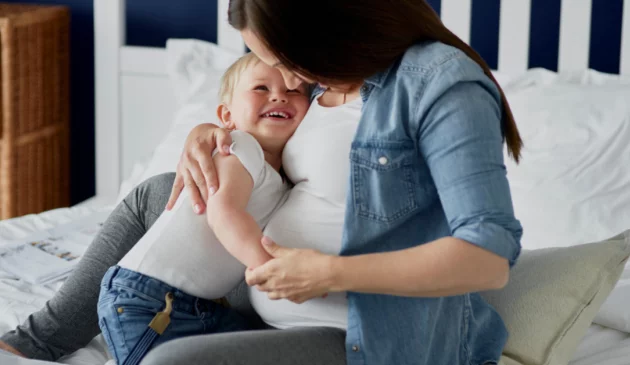 Pregnant woman hugging child
