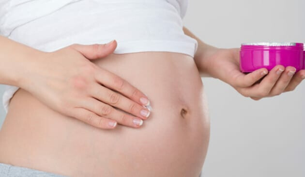 Woman rubbing in moisturiser