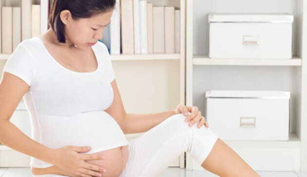 pregnant woman touching stomach