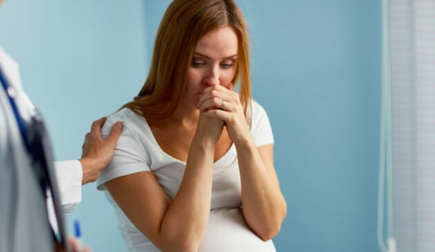 Pregnant woman worried in hospital