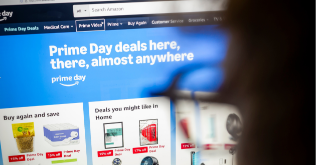 A woman looks at Prime Day landing page on Amazon on a laptop