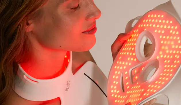 Woman using Project E Beauty LED face mask