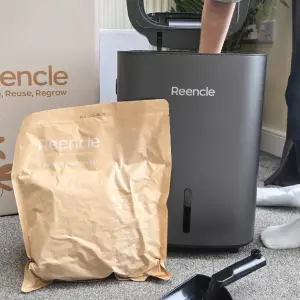 A child helps set up the Reencle Prime Electric Composter