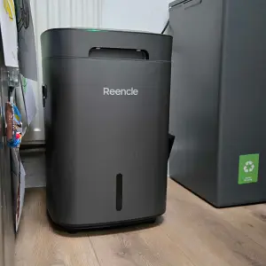 A view of the Reencle Prime Electric Composter in Rebecca's kitchen next to the bins