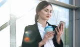 woman holding reusable coffee cup