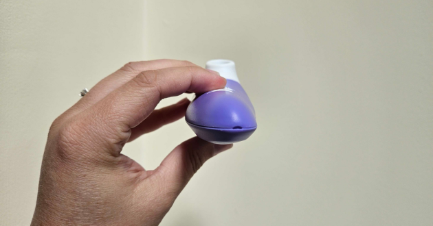 A side view of a hand holding the Lovehoney ROMP Switch