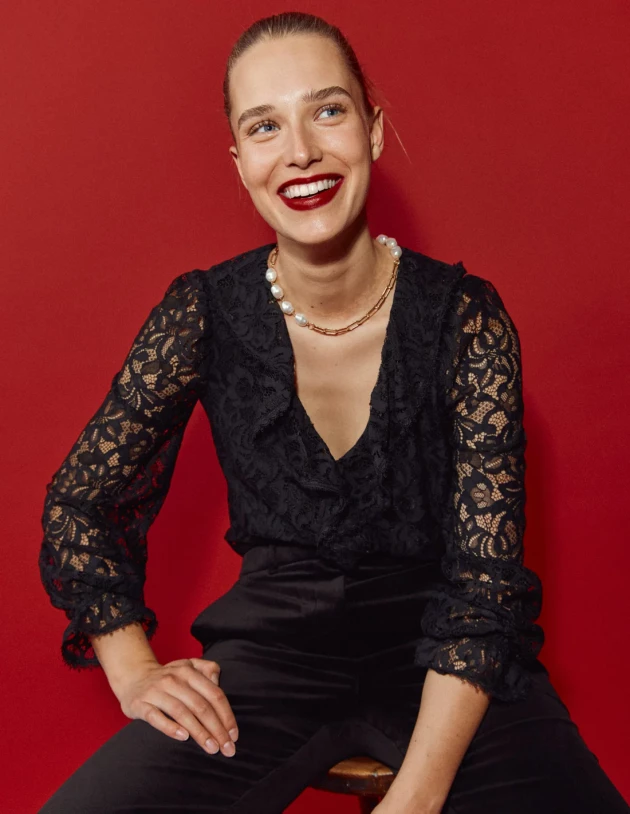 A model wears Boden's Ruffle Detail Lace Blouse