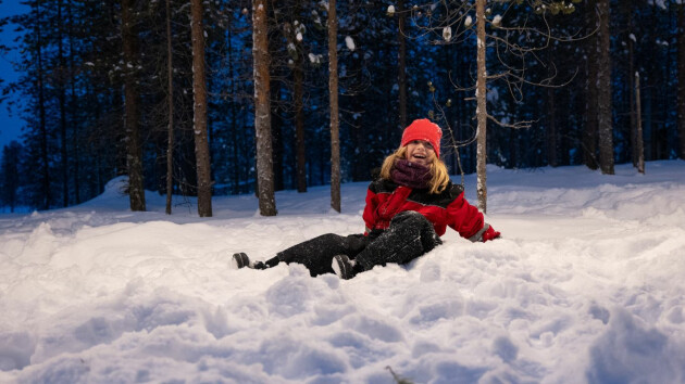 A child in a snowsuit on the snow in Finnish Lapland on a Santa's Lapland holiday