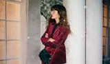 A model wearing Boden's velvet blazer jacket outside in the cold