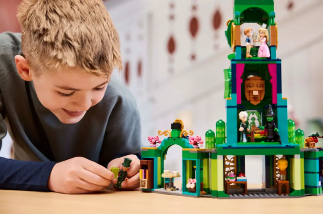 A young boy plays with Wicked's LEGO set