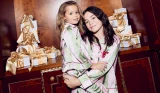 Two sisters wearing matching pyjamas from River Island for Christmas