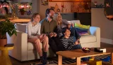 A family of four playing a multiplayer game on the Nintendo Switch together