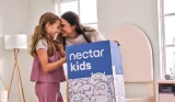 A mother and hcild opening a Nectar Kids mattress box