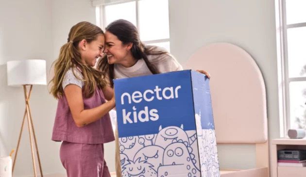 A mother and hcild opening a Nectar Kids mattress box