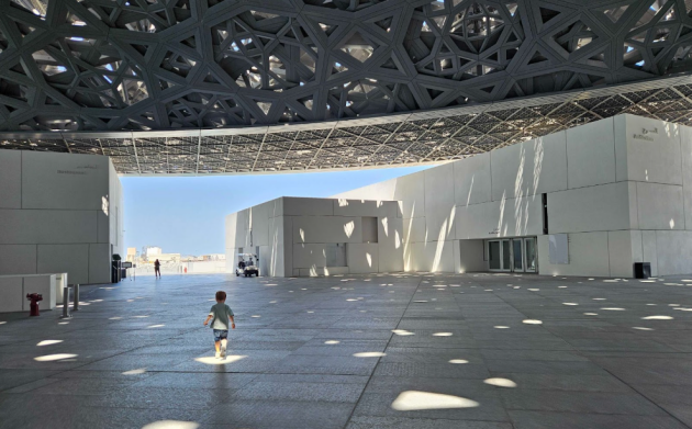 A child runs underneath the dome at Louvre Abu Dhabi