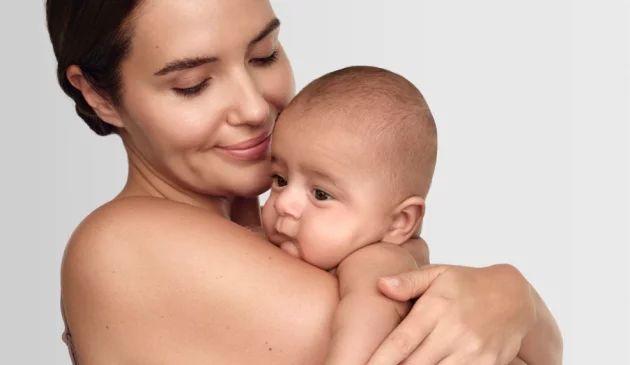 A mother holds her baby